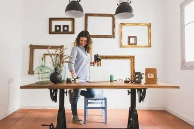 Happy woman checking documents and holding a camera