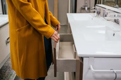 Female hand holding a white drawer on a store