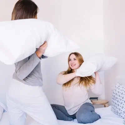 Women having pillow fight