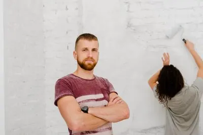 Man near woman making renovation