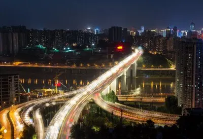city interchange overpass at night with purple light show in chong qing