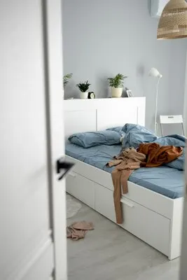 High angle messy bedroom with clothing