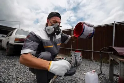 Full shot man working with paint