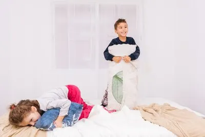 Three small children laughing and playing together