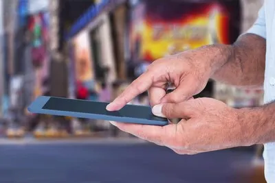 Close-up of finger touching the tablet's screen