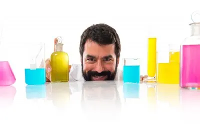 Scientist hiding behind test tubes