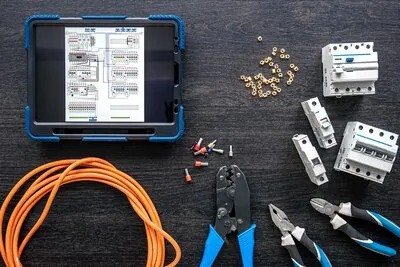 Different electrical tools and digital tablet on wooden background flat lay
