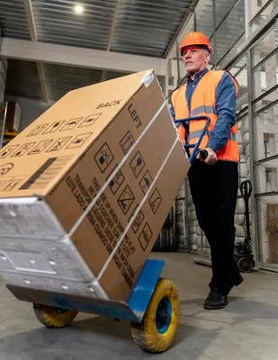 Man with helmet carrying boxes