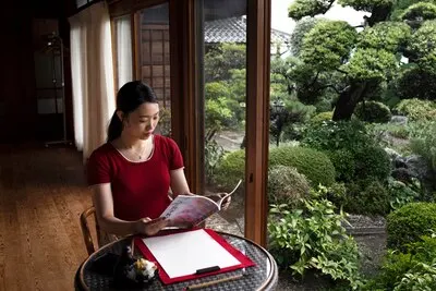Woman practicing japanese handwriting indoors