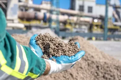 Person holding shredded paper used as an alternative fuel