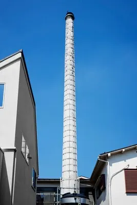 Low angle tall chimney near buildings