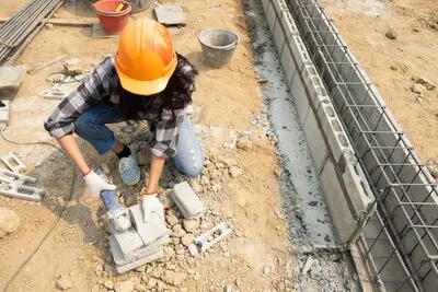 Round saw in the hands of the Builder, work on laying paving slabs.