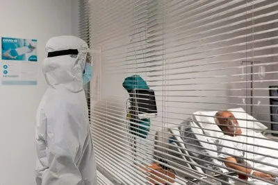 Doctor looking at a patient through a window