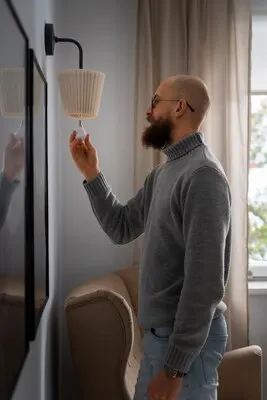Man turning off light bulb during energy crisis