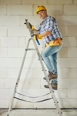 High ladder as a support for carpenter worker