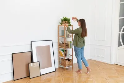 Full shot woman watering plant