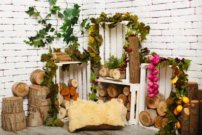 A front view room with wooden white with pieces of wood and leafs along with fruits