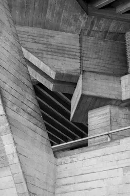 Vertical greyscale shot of an old attic with wooden ceiling