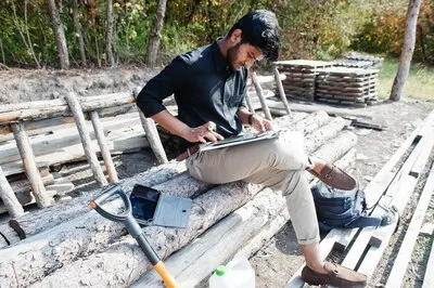 South asian agronomist farmer looking at diagram papers on farm Agriculture production concept