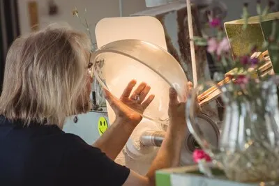 Glassblower polishing and grinding a glassware