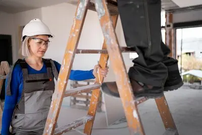 Woman standing on ladder for balance