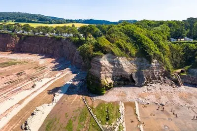 Aerial shot of St Audries Bay and waterfall in West Quantoxhead on sunny summer day