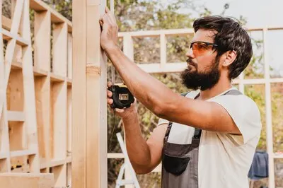 Carpenter man using a tape measure