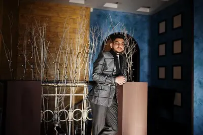 Young indian handsome business man at evening suit on restaurant