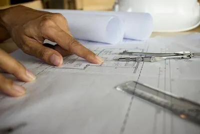 Hands of Engineer working on blueprint,Construction concept. Engineering tools.Vintage tone retro filter effect,soft focus(selective focus)
