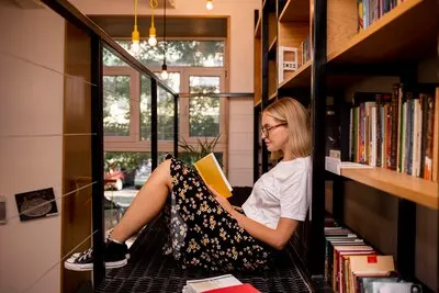 Student reading a book at the library