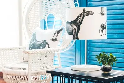 Armchair with a horse cushion and a lamp with horses