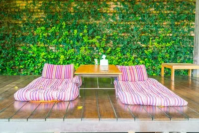 Relaxation space in garden with beds .