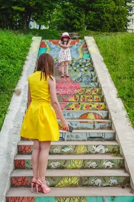 Mother and daughter playing on a ladder