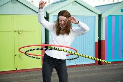Woman exercising with hula hoop circle