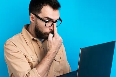 Shocked man looking at laptop