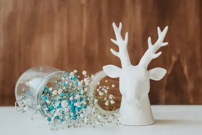 Floral composition with glass and deer