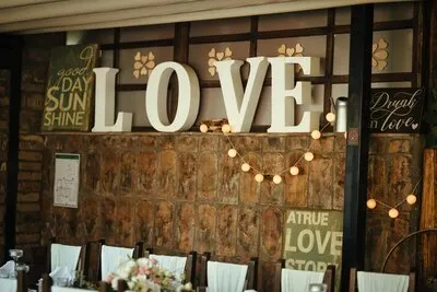 Love sign on a wall at wedding reception.