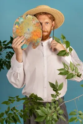 Front view man posing with painting palette