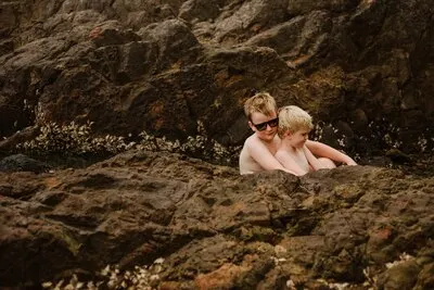Cute blonde brothers posing on the beach