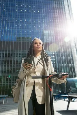 Medium shot woman with electric scooter outdoors