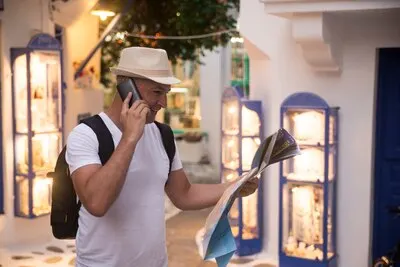 Man on business trip using his smartphone