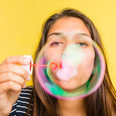 Brunette model blowing bubbles