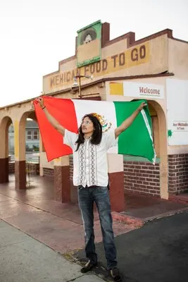 Full shot man holding mexican flag