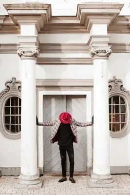 Stylish young male with hat posing outdoors