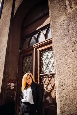 The stylish girl standing near building