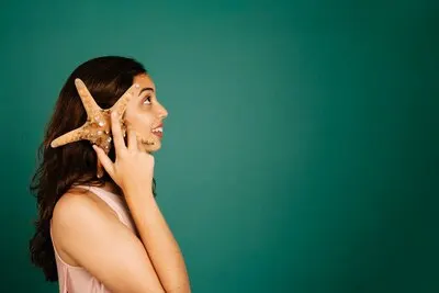 Side view of girl talking with starfish