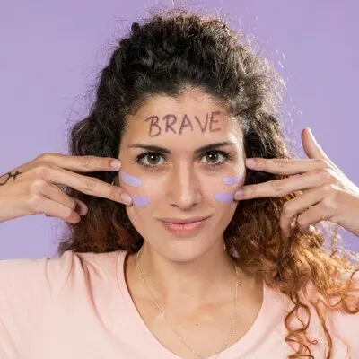 Portrait of young activist painting her face