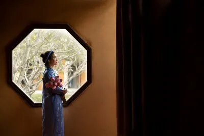 Young woman with flower bouquet wearing ao dai costume