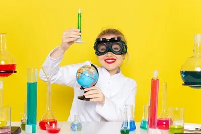 Front view young female chemist in white suit with ed solutions working with them with mask smiling on the yellow space chemistry science s