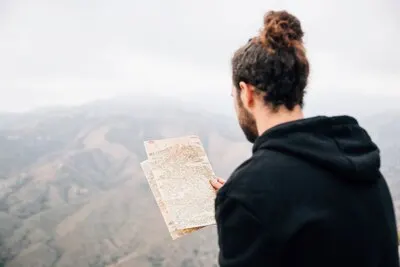 Close-up of a male hiker reading the map